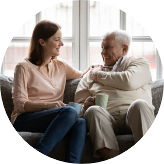 younger woman and older man having a  conversation on a couch